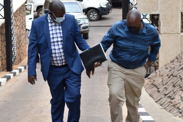 Suspected land grabbers handcuffed at CID headquaters.