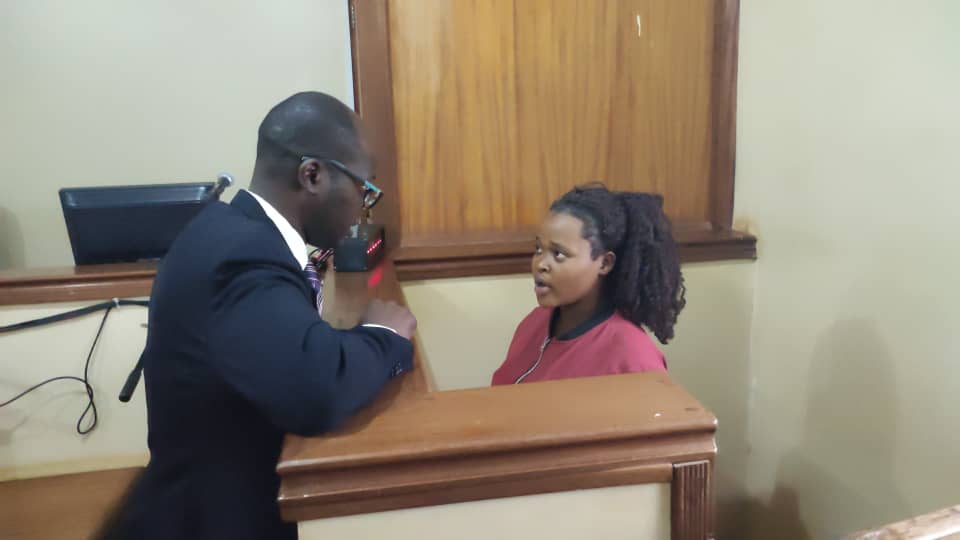 Sophia Nakibuule, a woman who burnt a two-year-old step daughter speaking to her lawyer, Hassan Kato.
