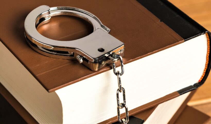 close-up-with-handcuffs-books