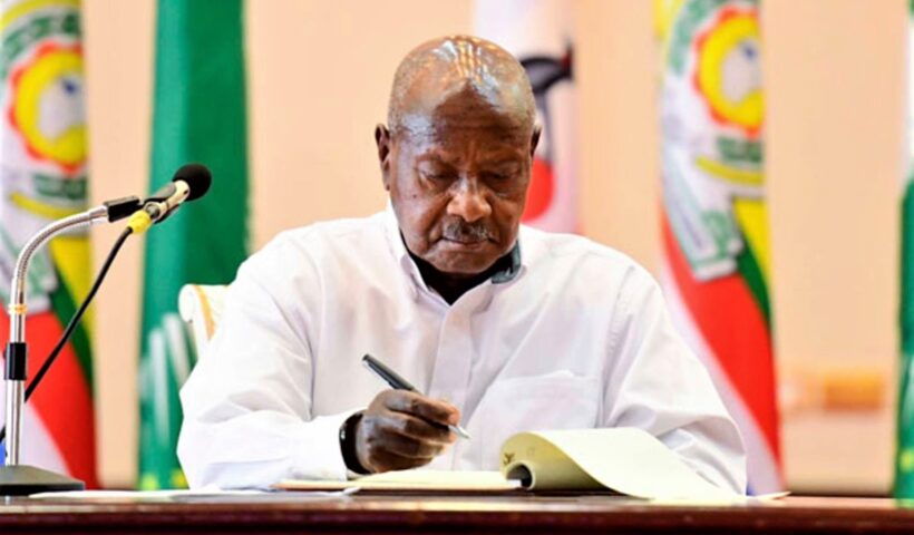 museveni signing one of the bills