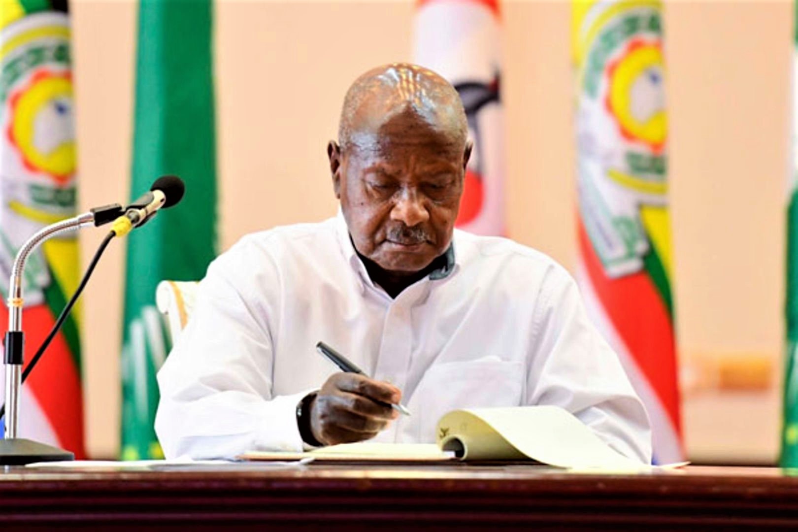 museveni signing one of the bills