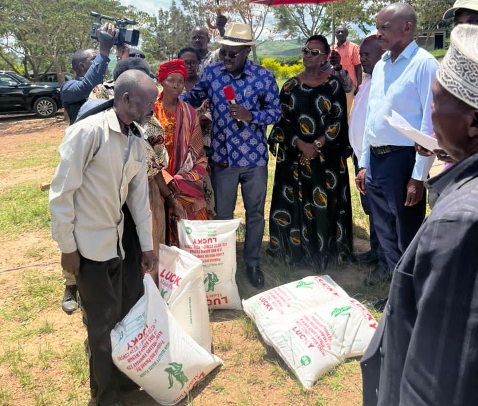 Mr Ben Kavuya and Ms Kavuya escorted by the District Chairperson delivering food consignment to the affected community. 