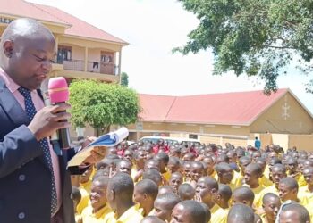 Henry Ssali Ssentongo, the Headteacher of St. Johns SSS, Namuyenje reading out UACE results to continuing students.