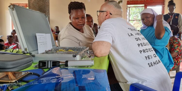 Luis Andres Bravo Alonso, a Senior Ophthalmologist attending to clients at Good Samaritan Primary School Nasuuti. Photos by Ivan Kimbowa.