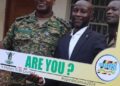 Luwero DISO Hillary Ayesiga, Bombo town LC 3 Chairperson Osman Ramathan and DPC John Ojokuna posing with UBOS placards for the census