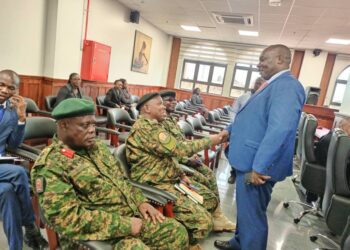Former Nakawa Member of Parliament Michael Kabaziguruka greeting UPDF representatives in the court