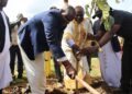 Kamuswaga and the state minister for gender, Balam Barugahara planting a tree at Ddwaniro sub county.