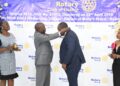Past District Governor 9214 Mr Peace Taremwa(2rd left) installing Dr Steven Sseruyange as new President Rotary Club of Nsangi in Maya Wakiso District on Sunday .Looking on( right )Mrs Sseruyanga and Ms Enid Tusi