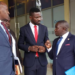 NUP President Robert Kyagulanyi speaking with his lawyers Benjamin Katana and George Musisi at the UHRC Offices on Monday