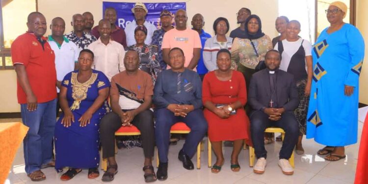 Local eaders posing for a photo with Rotarians after the meeting, In the Middle is President Elect, Dr. Charles Olaro
