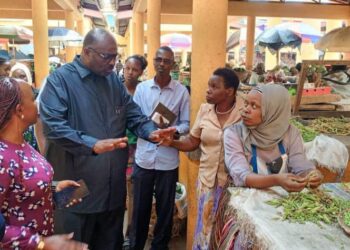 Ben Kumumanya, the Permanent Secretary of the Ministry inspecting PDM beneficiaries at Fortportal Markert
