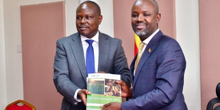 Auditor General, Edward Akol handing over the report the Deputy Speaker Thomas Tayebwa