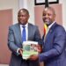 Auditor General, Edward Akol handing over the report the Deputy Speaker Thomas Tayebwa