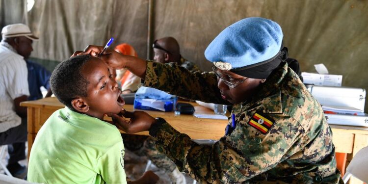 UPDF medical officer examining a boy at the medical camp. Courtesy Photo.