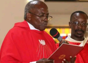 Msgr. Charles Kasibante reading from the Missal during Mass in a previous occasion.
