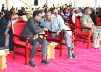 Minister for Security, Maj. Gen. Jim Muhwezi having a light moment with former Inspector General of Police, Gen. Kale Kayihura.