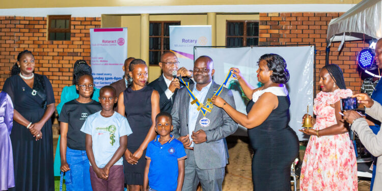 Rotary District 9213 Governor Martin Geoffrey Kitakule installs Isaac Ssamba as the new president of the Rotary Club of Mukono Central.
