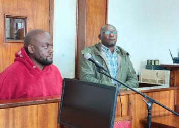 NUP's Noah Mitala, also known as Nuwa Mutwe (left), and former CID spokesperson Charles Mansio Twiine (right) appear before court.