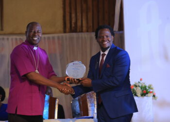 Ndamwesiga receiving an Excellence Award from the Chairperson of Uganda Christian University Council.