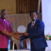 Ndamwesiga receiving an Excellence Award from the Chairperson of Uganda Christian University Council.
