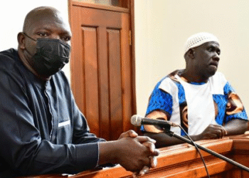 Former Flying Squad operatives Senior Superintendent of Police Nixon Agasirwe (left) and Abdulnoor Ssemujju, alias Minaana (right), appear before the Nakawa Chief Magistrates Court.