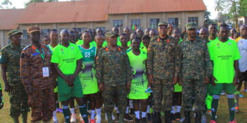 Wazalendo SACCO officials, UPDF participants, organisers, and hosts pose for a group photo after the handover of sports kits in Masaka.
