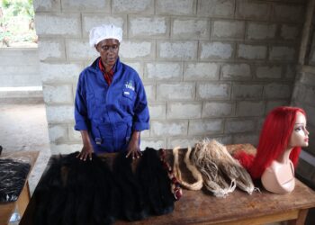 Faith Kabaguma, Head of Production at Texfad displaying hair fibers produced out of banana fibres.