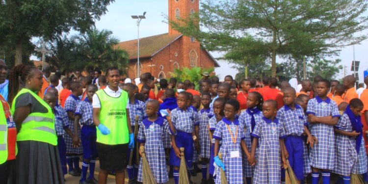 Pupils participate in a community clean-up drive in Masaka. Photos by Robert Nsubuga.