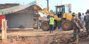 Authorities carry out an early morning demolition of roadside kiosks in Kikooza, Mukono Municipality, as part of an enforcement operation to clear illegal structures from road reserves.