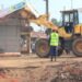 Authorities carry out an early morning demolition of roadside kiosks in Kikooza, Mukono Municipality, as part of an enforcement operation to clear illegal structures from road reserves.