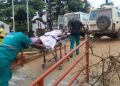 rancis Mpalanyi, Mukono municipal enforcement officer, is transferred to Mulago National Referral Hospital after sustaining serious head injuries during a road reserve kiosk demolition operation in Gunga Village.