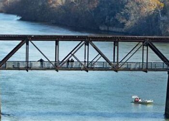 Doctoral Student Found Dead on Bridge; Roommate Charged as Search Continues for Another Student