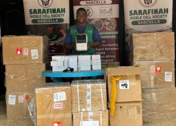 SASCELLS official displays a newly received consignment set for distribution to intended beneficiaries.