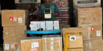 SASCELLS official displays a newly received consignment set for distribution to intended beneficiaries.