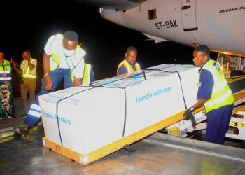 Family members receive the body of Timothy Muganzi Magambo, son of CID Director Tom Magambo, upon arrival at Entebbe International Airport.