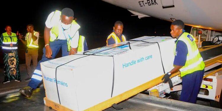 Family members receive the body of Timothy Muganzi Magambo, son of CID Director Tom Magambo, upon arrival at Entebbe International Airport.