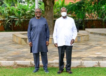 President Yoweri Museveni poses for a photo with Nigerian businessman Aliko Dangote after discussions on the proposed East African regional refinery at Nakasero.