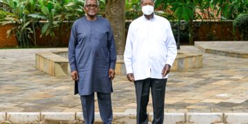 President Yoweri Museveni poses for a photo with Nigerian businessman Aliko Dangote after discussions on the proposed East African regional refinery at Nakasero.