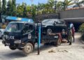 Security teams tow away impounded vehicles for forensic examination during an ongoing investigation.