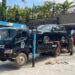 Security teams tow away impounded vehicles for forensic examination during an ongoing investigation.