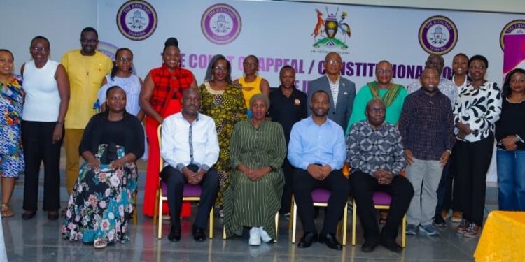 Lady Justice Mary Kisakye (seated centre, front row) poses for a group photo with newly elected UJO-SACCO executive committee members and judicial officers after the Annual General Meeting in Kampala on Saturday.