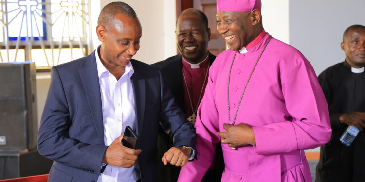 Archbishop Stephen Kaziimba Mugalu and Aaron Mushengyezi during discussions on Martyrs Day preparations at Namugongo.