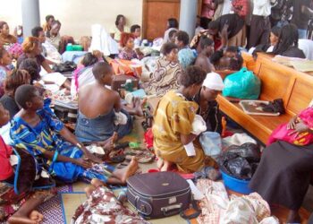 Mothers sit in a maternity ward at a health facility, awaiting care and reflecting ongoing demand for maternal health services.