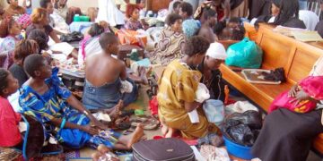 Mothers sit in a maternity ward at a health facility, awaiting care and reflecting ongoing demand for maternal health services.