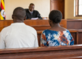 Graphic illustration of a couple appearing before court during a criminal trial.