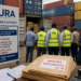 URA officials and customs officers inspecting containers at a busy port as importers’ documents lie ready for clearance, highlighting the official cargo verification process amid growing concerns over illegal charges in the logistics chain.