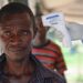 Medical personnel carry out Ebola screening measures at a border point between Uganda and DR Congo.