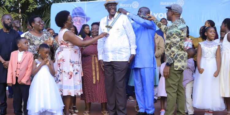 Outgoing leaders and District officials formally hand over Rotary insignia to Rtd. ACGP David Sekabembe Nsalasatta as he is installed as the 6th President of the Rotary Club of Sonde during a colorful Charter Night ceremony in Sonde.