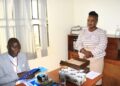 Kaliisizo Town Council Chairperson (Mayor) Richard Sande Ntambaazi handing over the official handover report to the Town Clerk, Resty Nabatanzi, marking the end of his 20-year tenure.