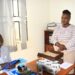 Kaliisizo Town Council Chairperson (Mayor) Richard Sande Ntambaazi handing over the official handover report to the Town Clerk, Resty Nabatanzi, marking the end of his 20-year tenure.